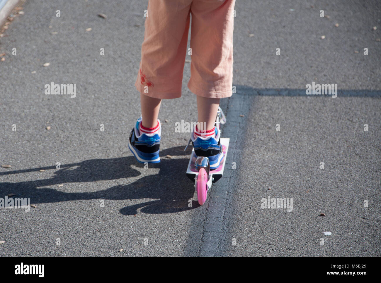 Child On A Scooter Stock Photo