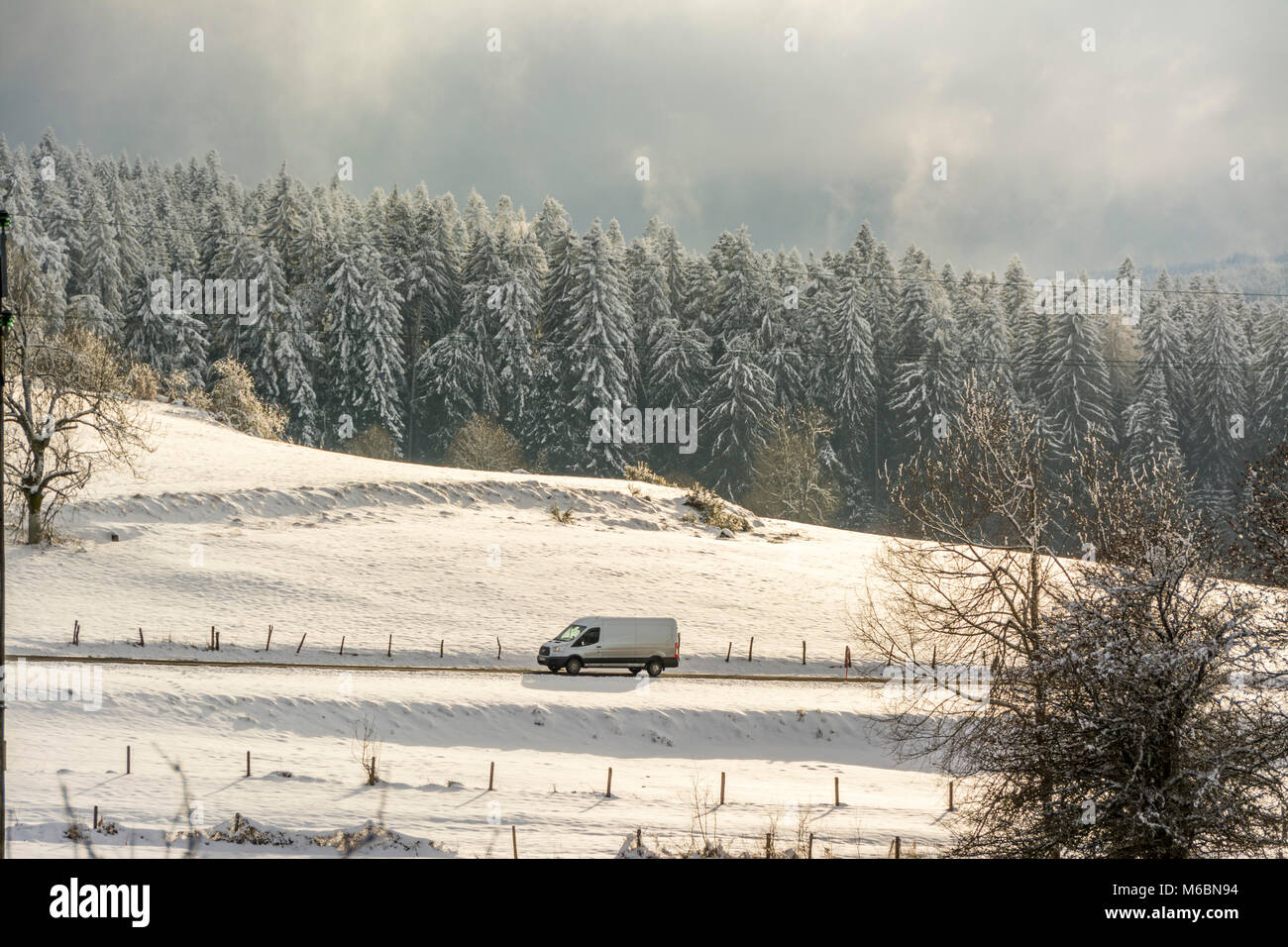 Delivery van in winter, Livradois Forez, Puy de Dome, Auvergne, France Stock Photo