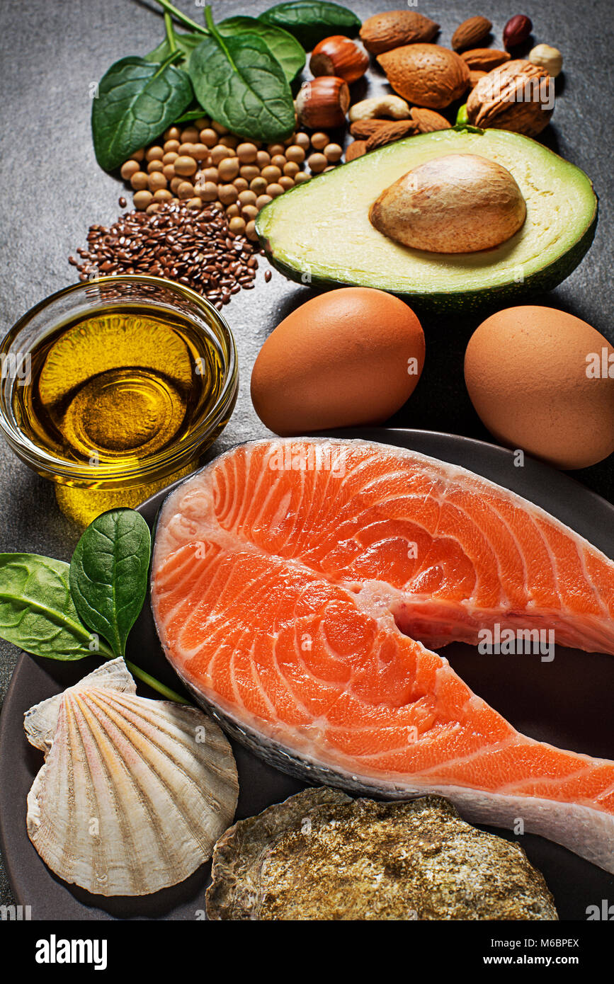 Selection of healthy fat food. Raw steak of salmon with fresh