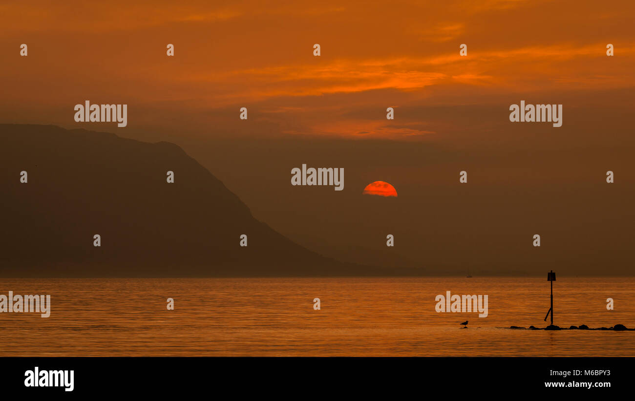 Colourful sunset with clouds over the North Wales coast Stock Photo