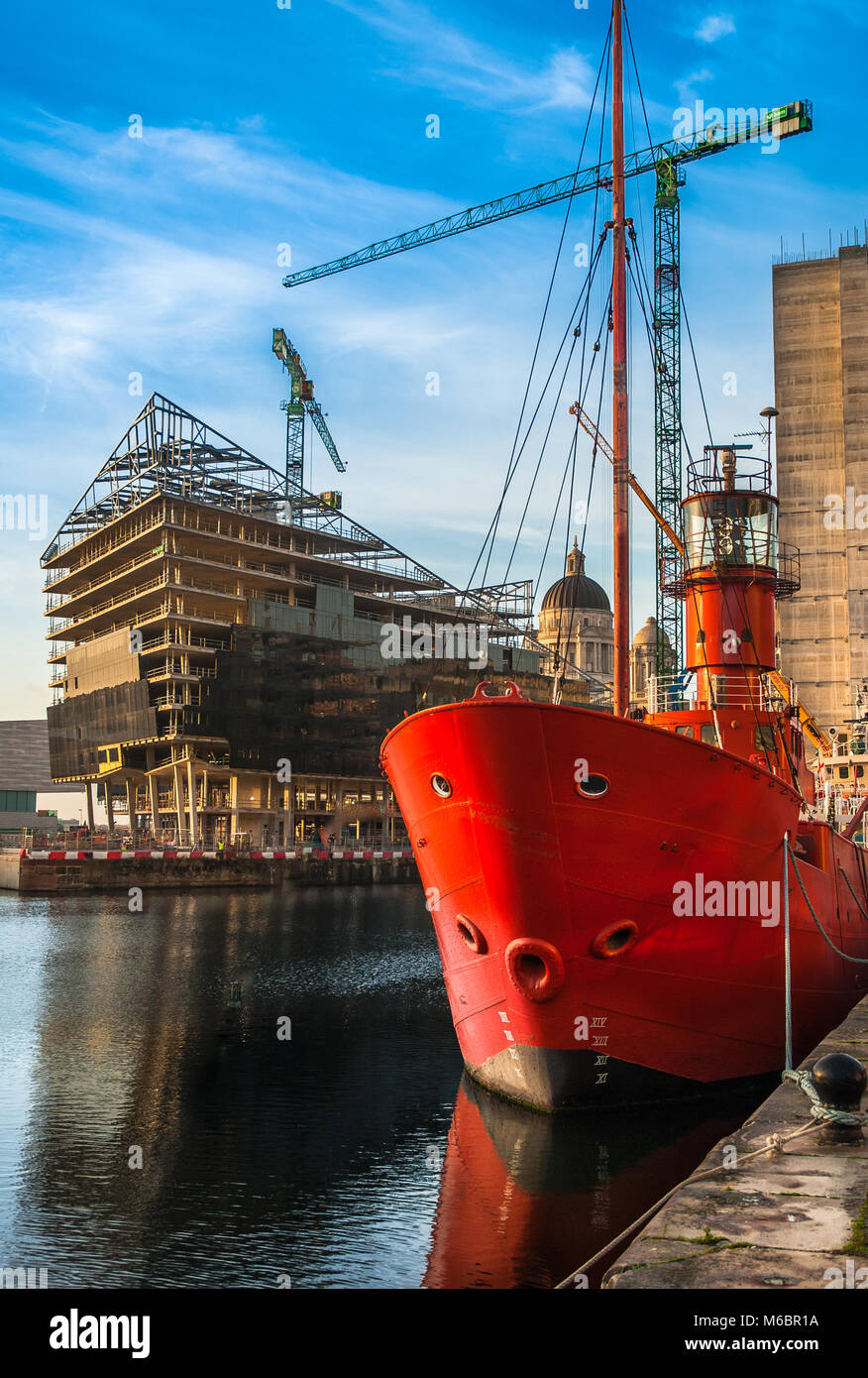 New buildings being constructed at mann Island, including the RIBA with the Mersey Bar Lightship vessel Planet in the foreground in Canning Dock. Stock Photo
