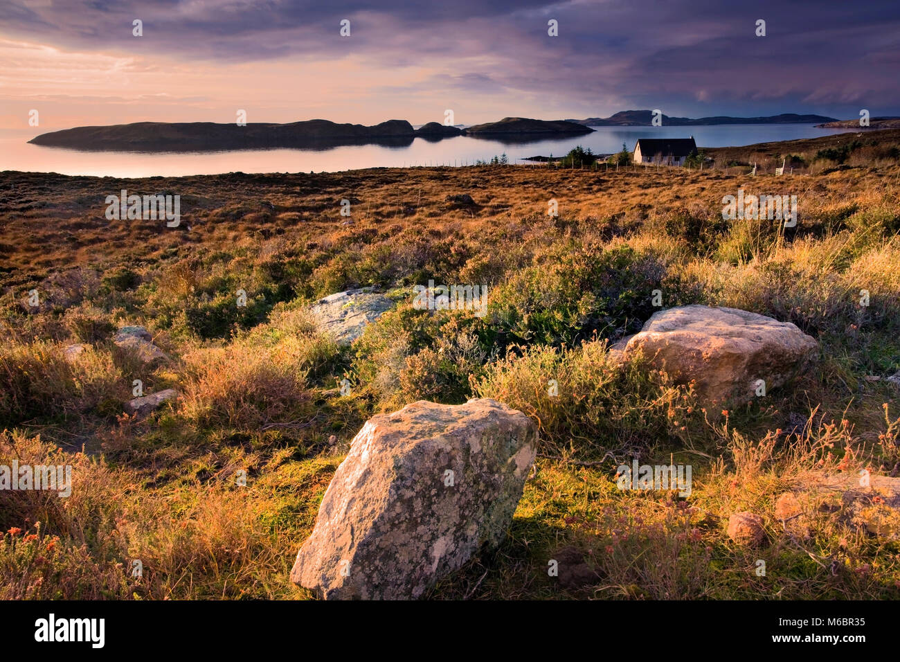 A winter view across the Wester Ross coast looking towards the Summer Isles as the sun sets. Stock Photo