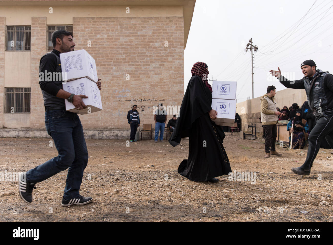 Mosul, Iraq. 8th December 2016 - Mosul locals carry aid to their homes as an operation to remove Daesh is underway - © Ty Faruki Stock Photo