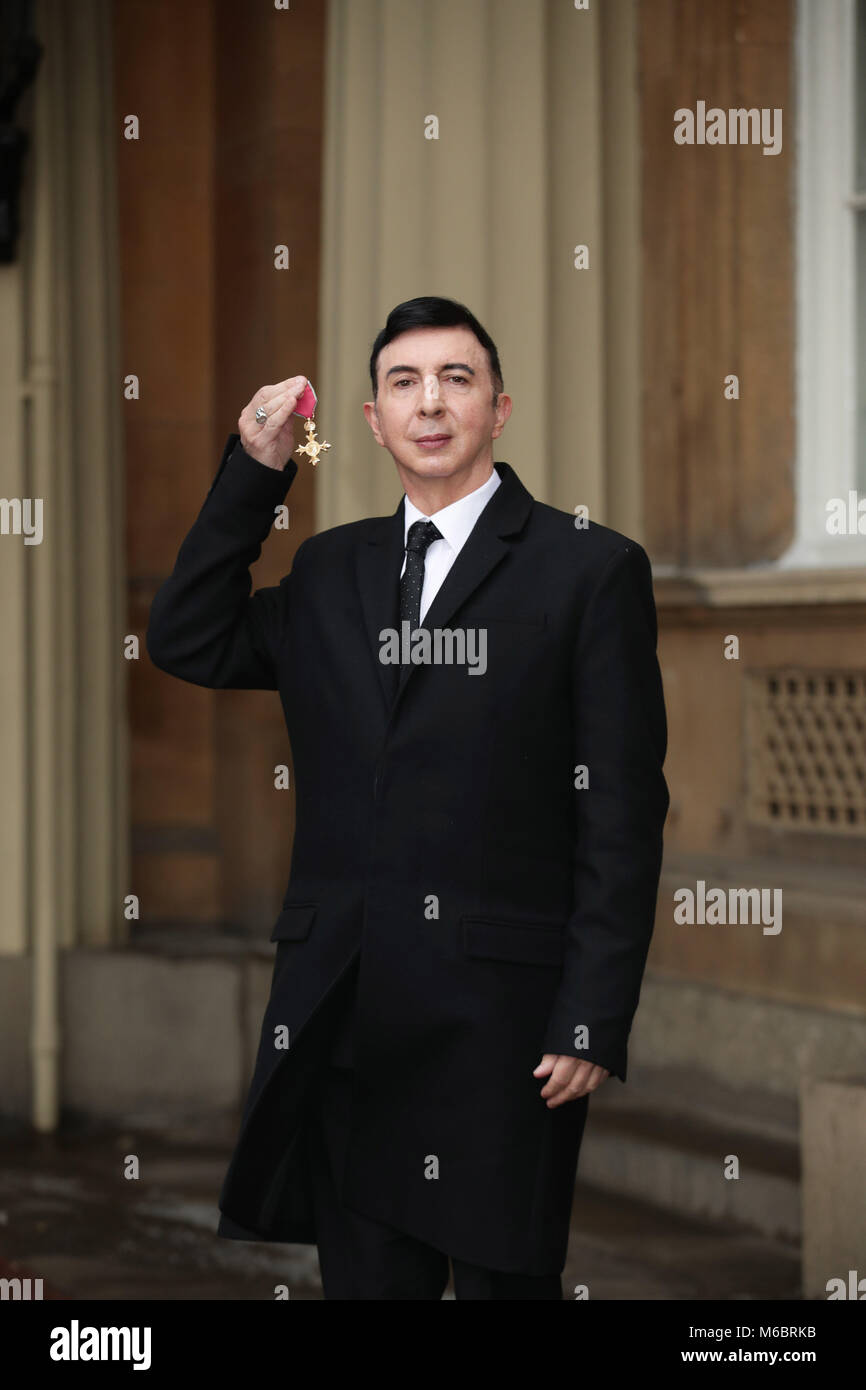 Soft Cell frontman Marc Almond holds his OBE following an investiture ceremony at Buckingham Palace, London. Stock Photo