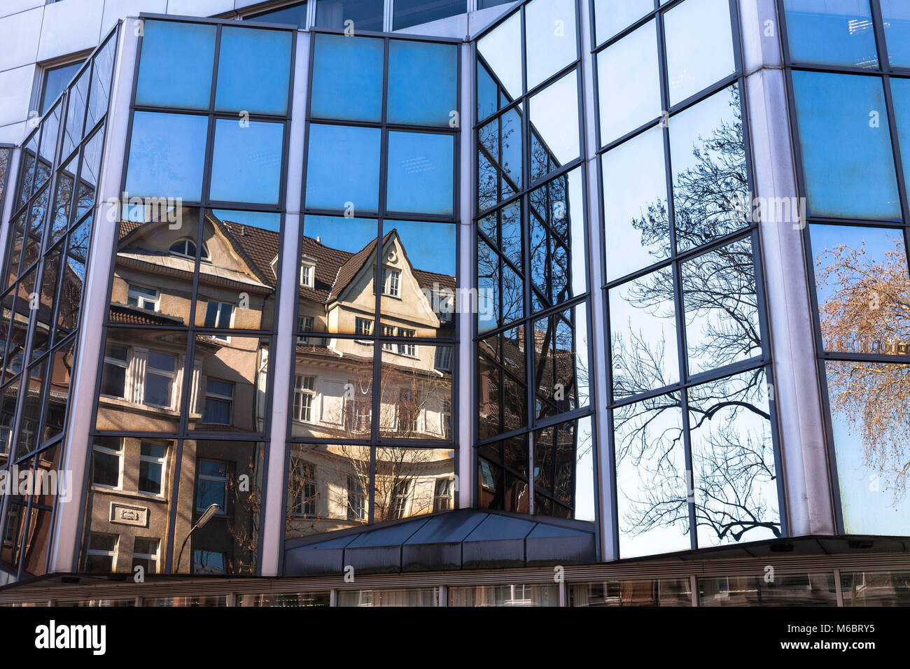 Germany, Cologne, old buildings in the Neuhoeffer street are reflected in the facade of the building of the Landschaftsverband Rheinland in the distri Stock Photo