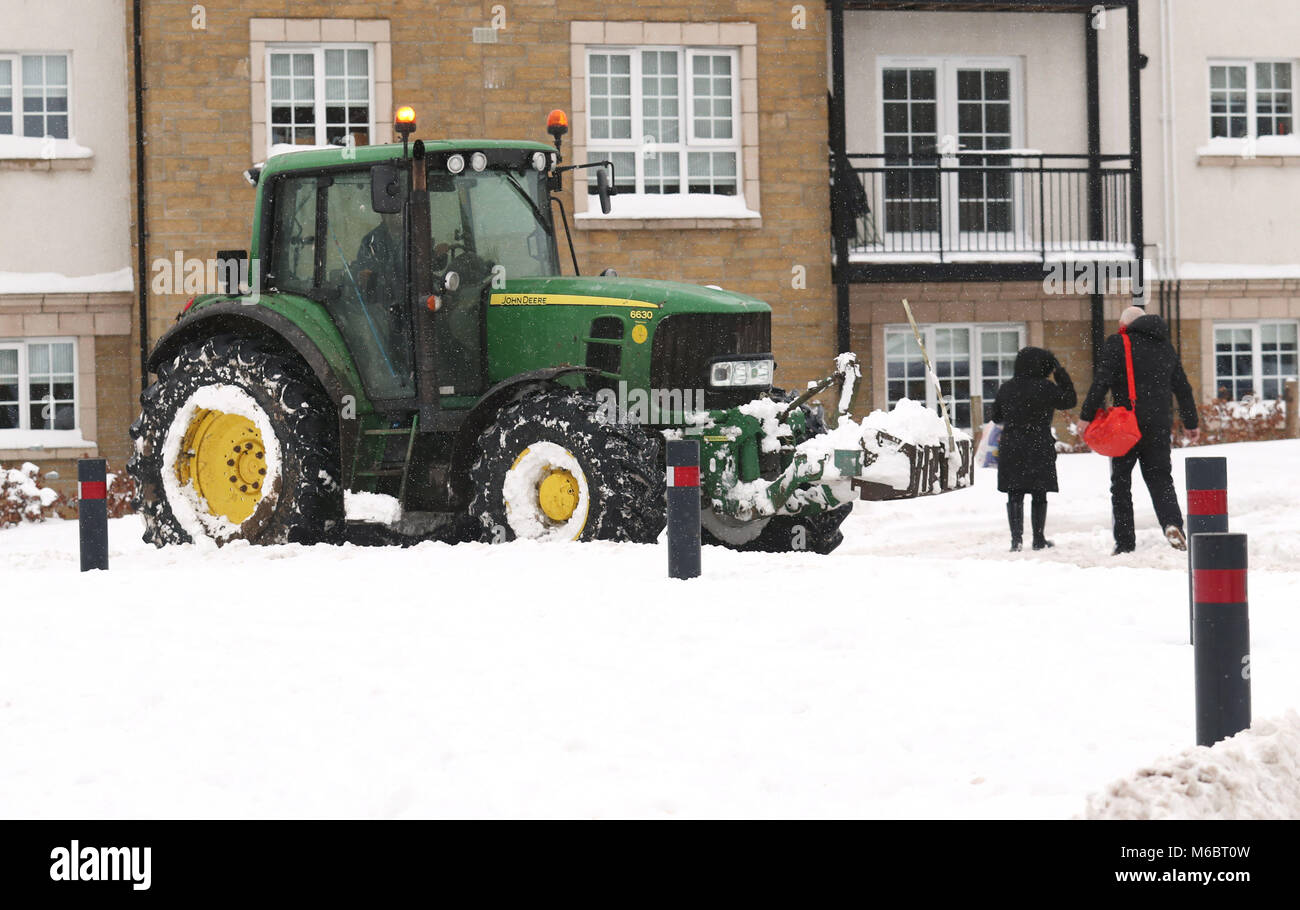 A tractor clears snow from a housing estate in Larbert, near Falkirk, as roads and railways have been rendered impassable by the coldest start to March on record, stranding hundreds of people in treacherous conditions. Stock Photo