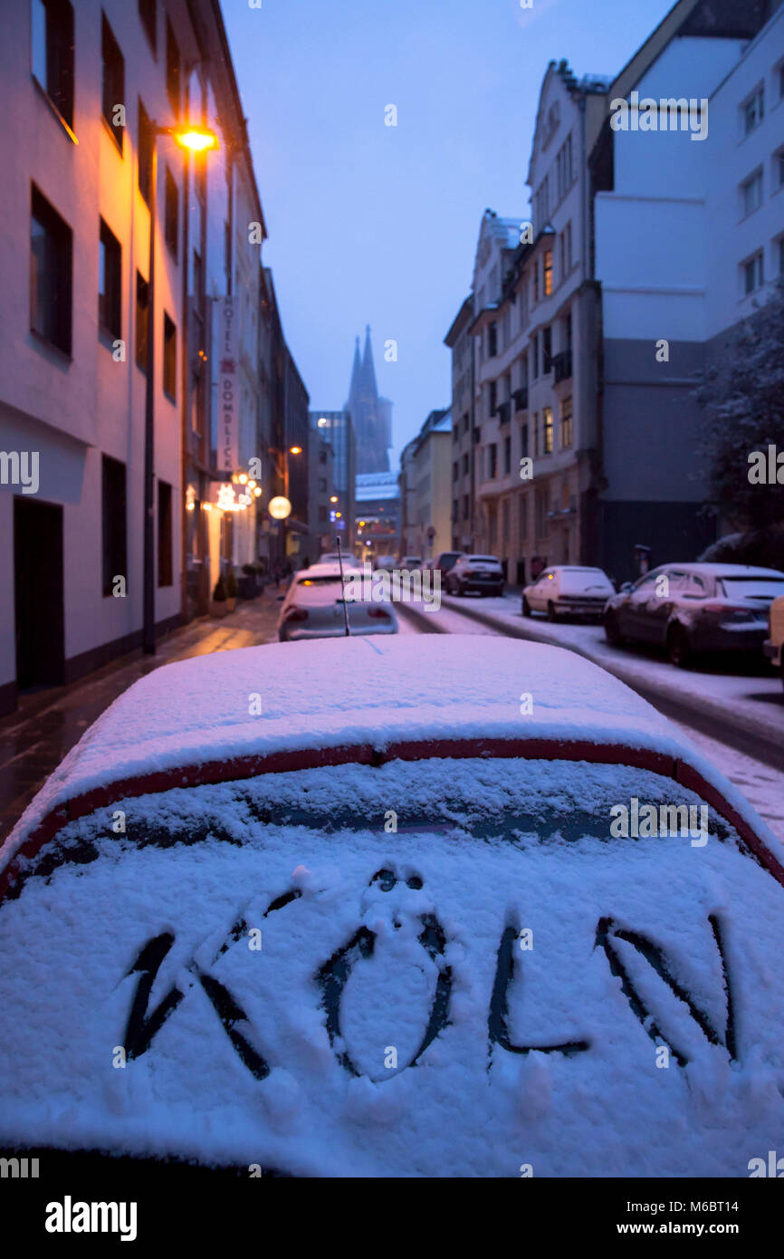 Germany, Cologne, the Dom street, view to the cathedral, winter, snow-covered car with Koeln (Cologne) writing on the rear window.  Deutschland, Koeln Stock Photo