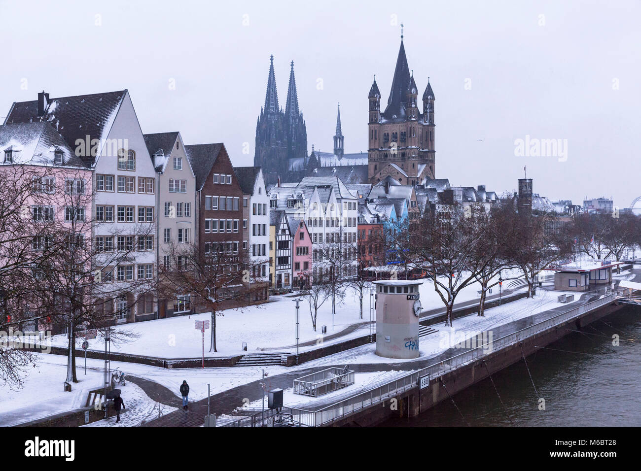 Germany, Cologne, houses in the old part of the town at the Frankenwerft, the cathedral and the church Gross St. Martin, winter, snow.  Deutschland, K Stock Photo