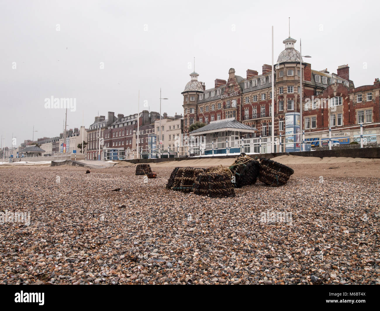 Lobster pots washed out on Weymouth beach. Royal hotel in the background Stock Photo