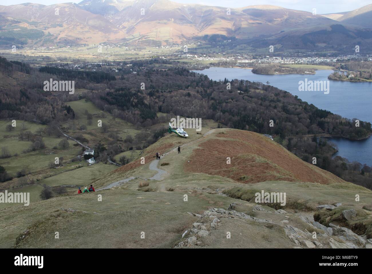 The Great North Air Ambulance medical helicopter landed on Cat Bells mountain near Keswick to allow a doctor to treat an injured walker. Stock Photo