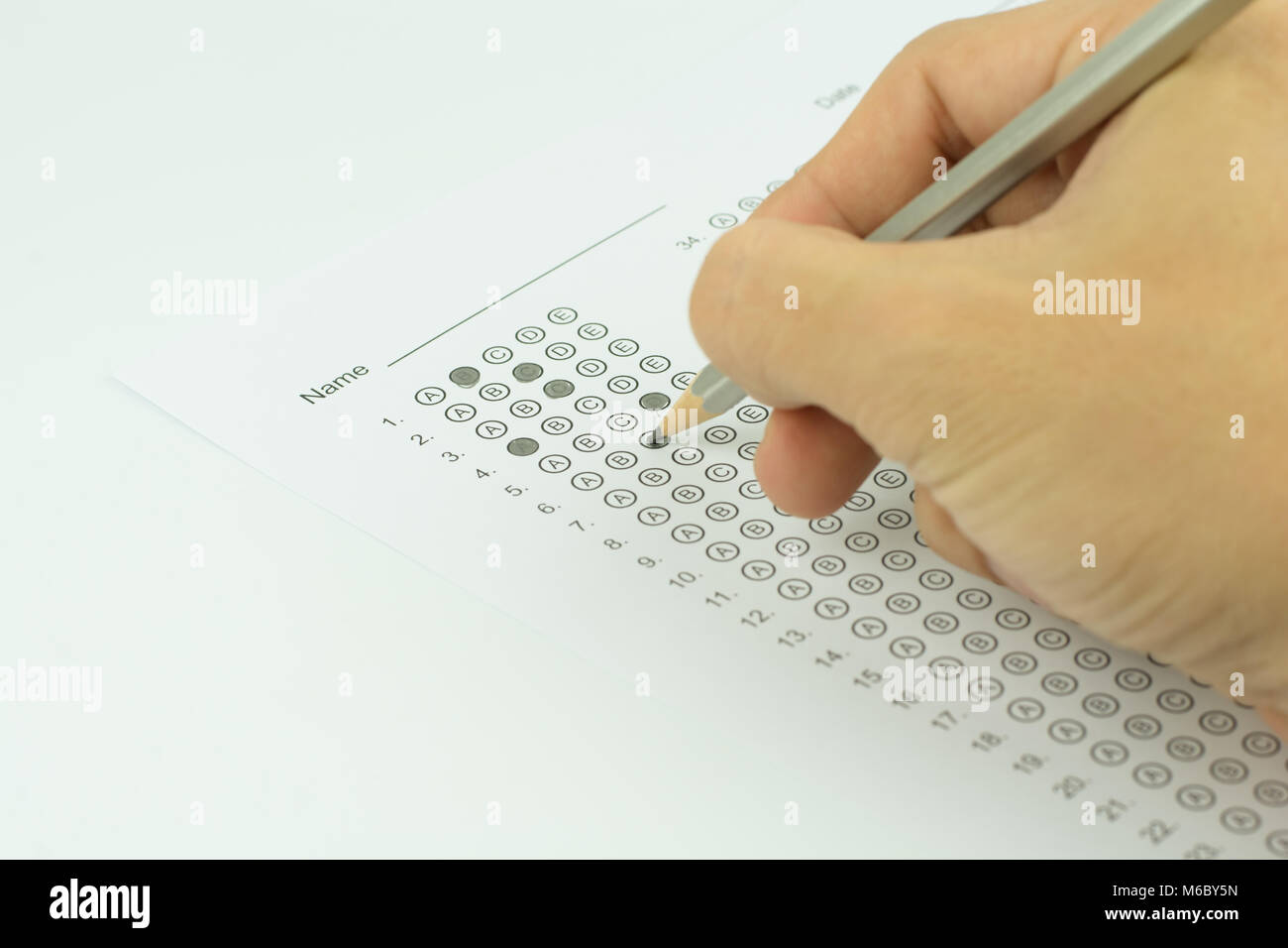man hands filling in standardized test form Stock Photo - Alamy