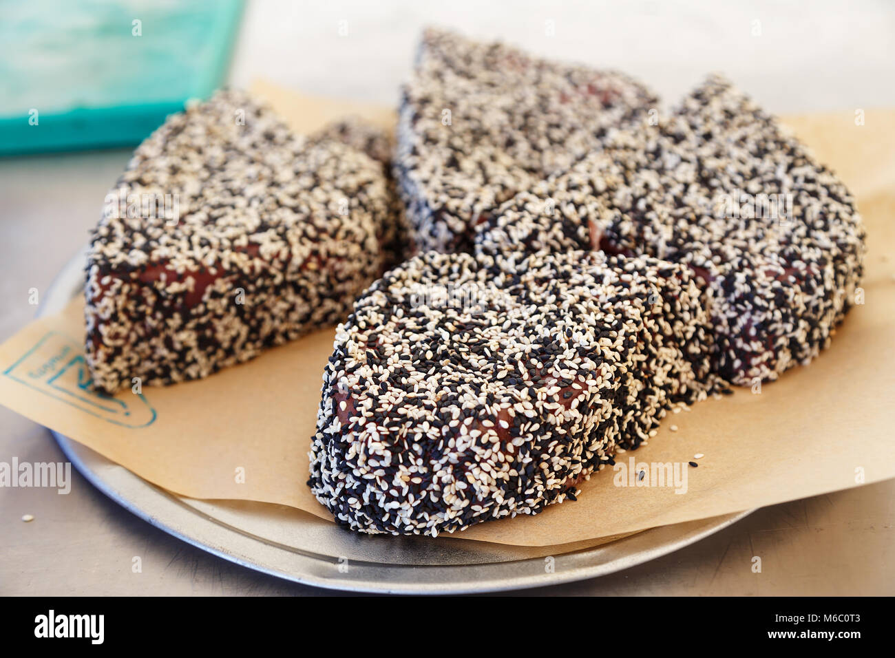 Cooked steaks of tuna in black and white sesame on a plate Stock Photo