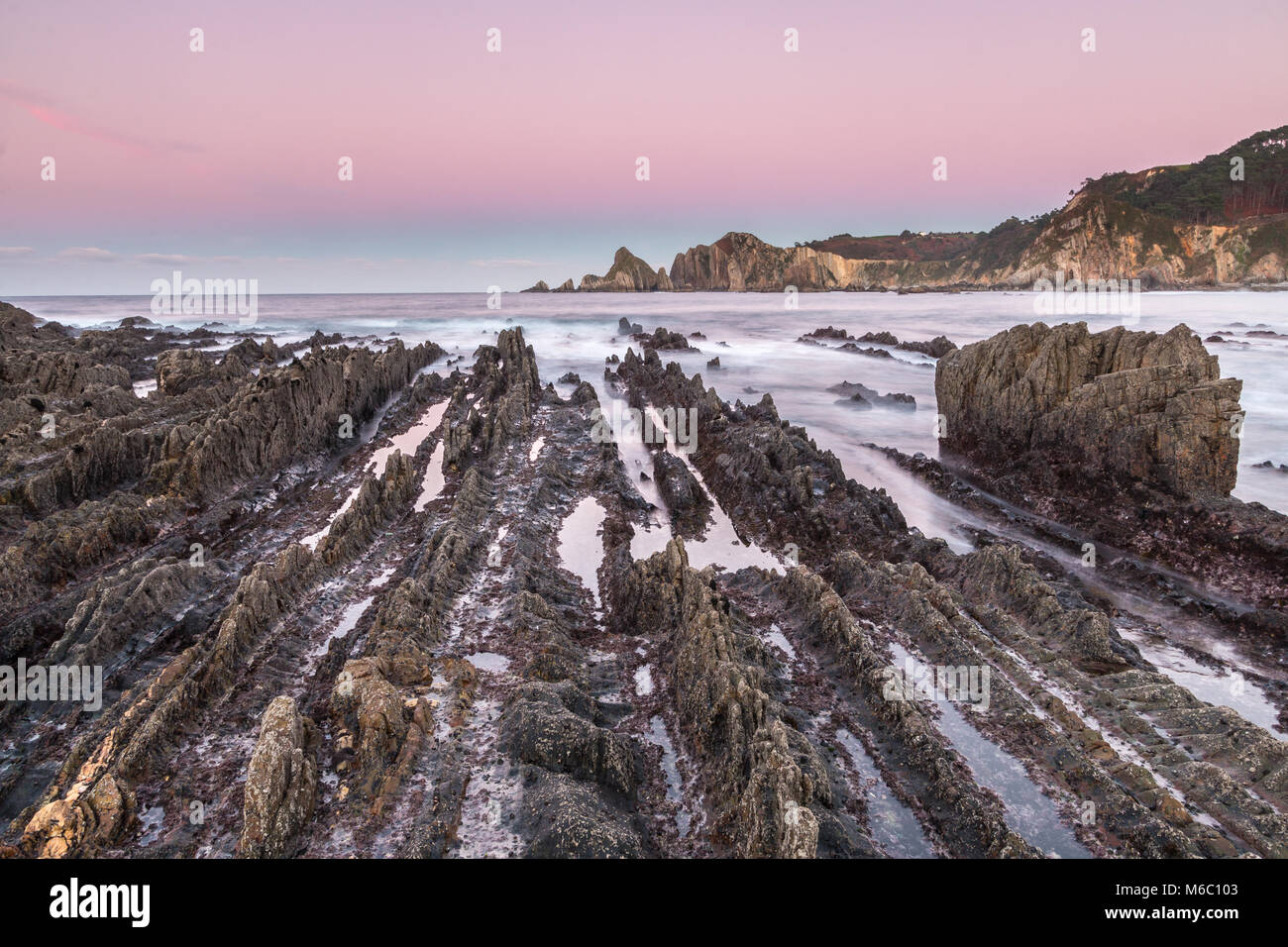 the beach of Gueirua, a disturbing landscape of sharp rocks that emerge ...