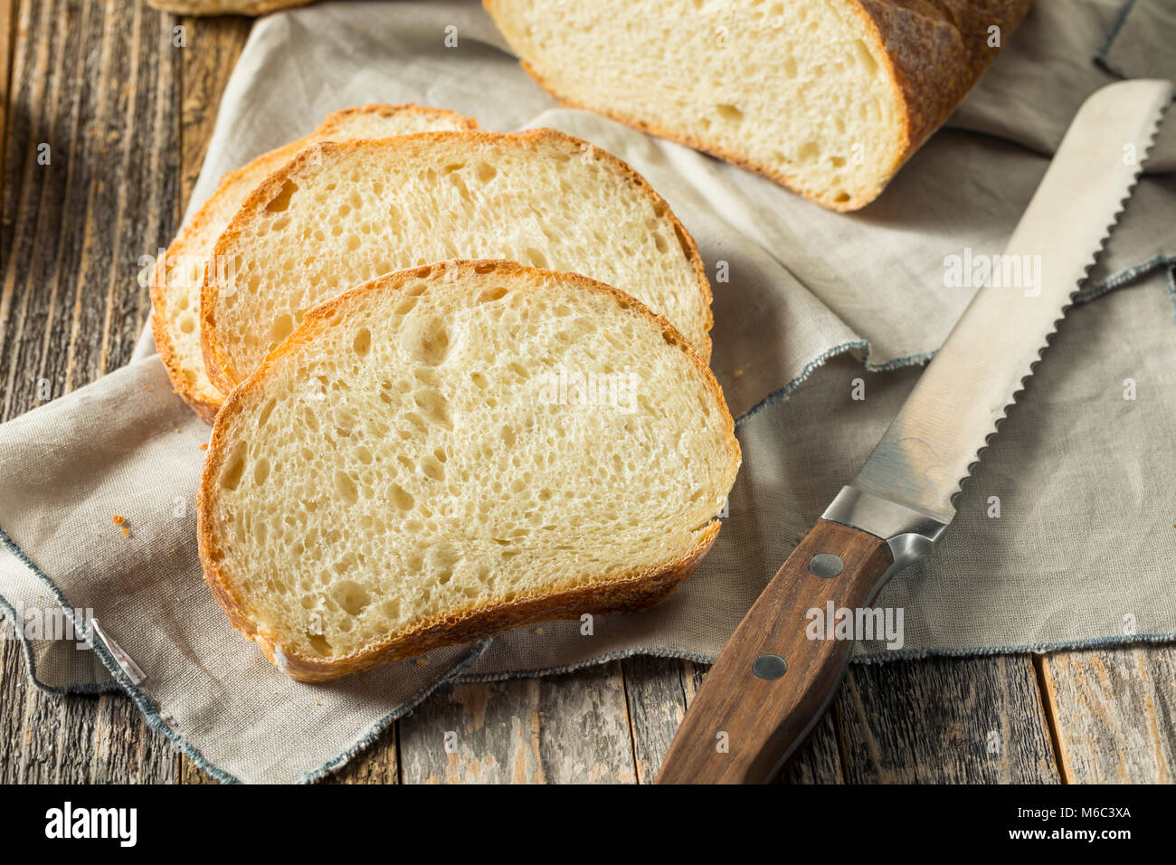 Whole Grain White French Bread Cut into Slices Stock Photo