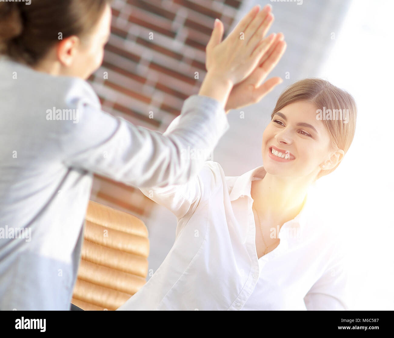 members of the business team giving each other a high five Stock Photo ...