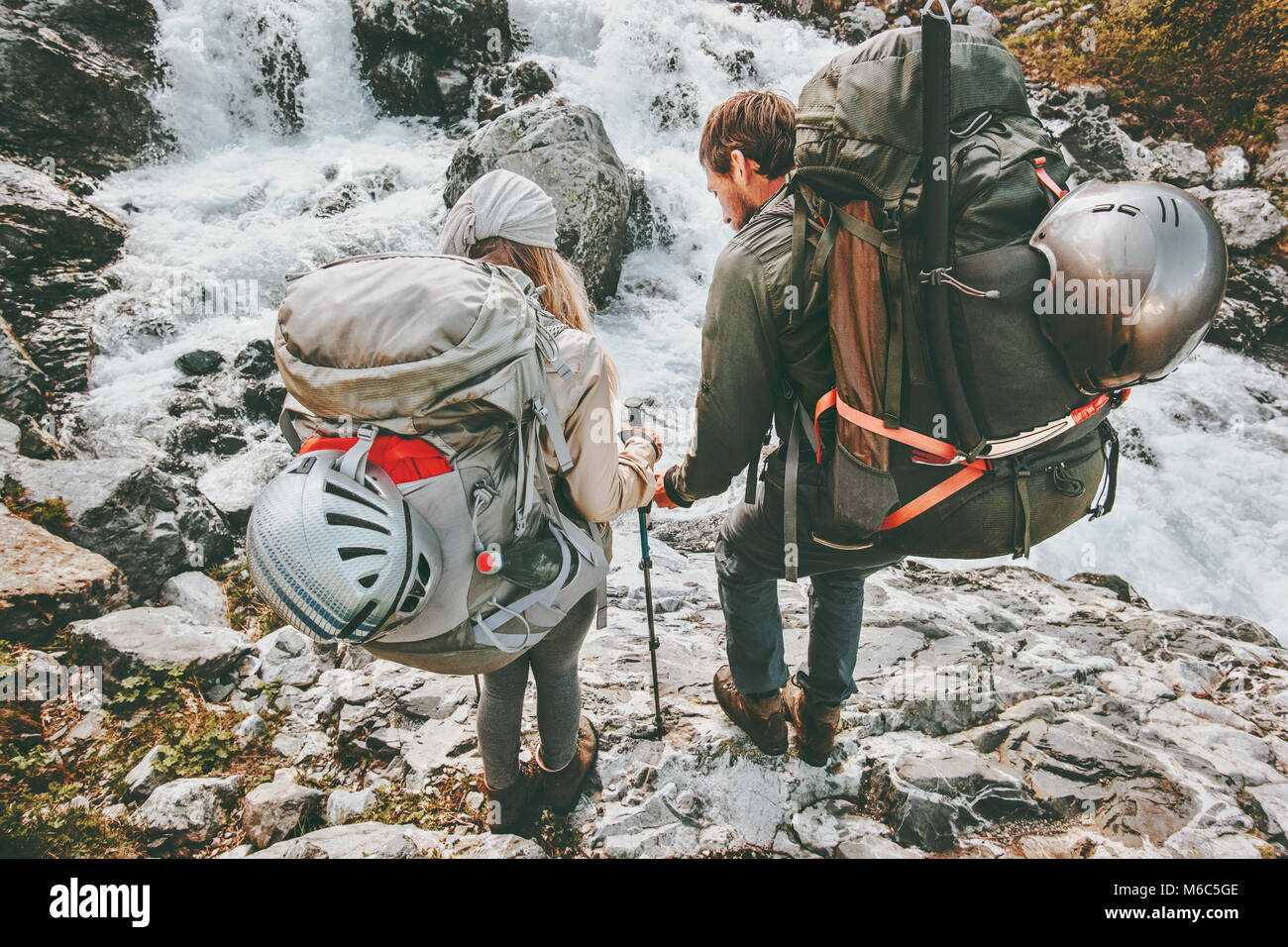 Couple backpackers friends hiking in mountains at river love and Travel Lifestyle wanderlust concept adventure vacations outdoor Stock Photo