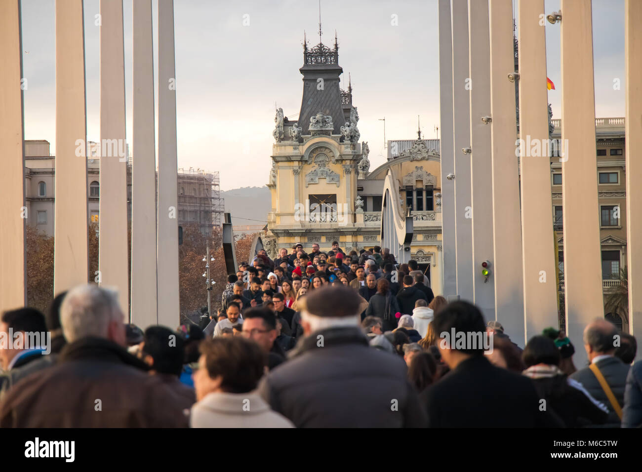 people are crossing the bridge in Barcelona Stock Photo