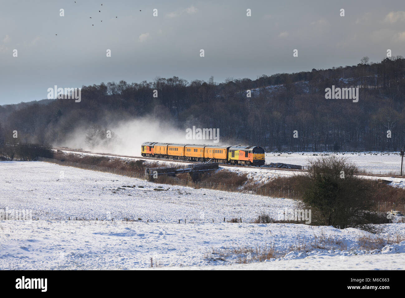2 Colas Rail Freight class 67 locomotives hauling a  Network Rail infrastructure monitoring train through the snow on the Cumbrian coast line Stock Photo