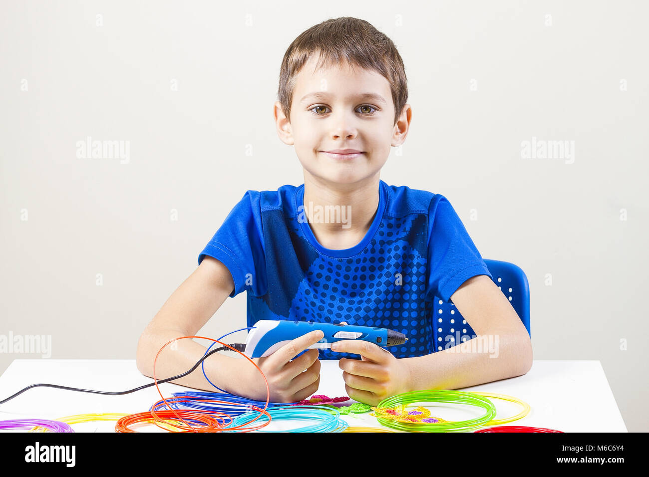 Child creating with 3d printing pen Stock Photo - Alamy