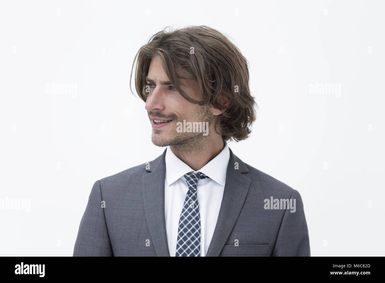 Handsome man in stylish clothes is looking away and smiling Stock Photo