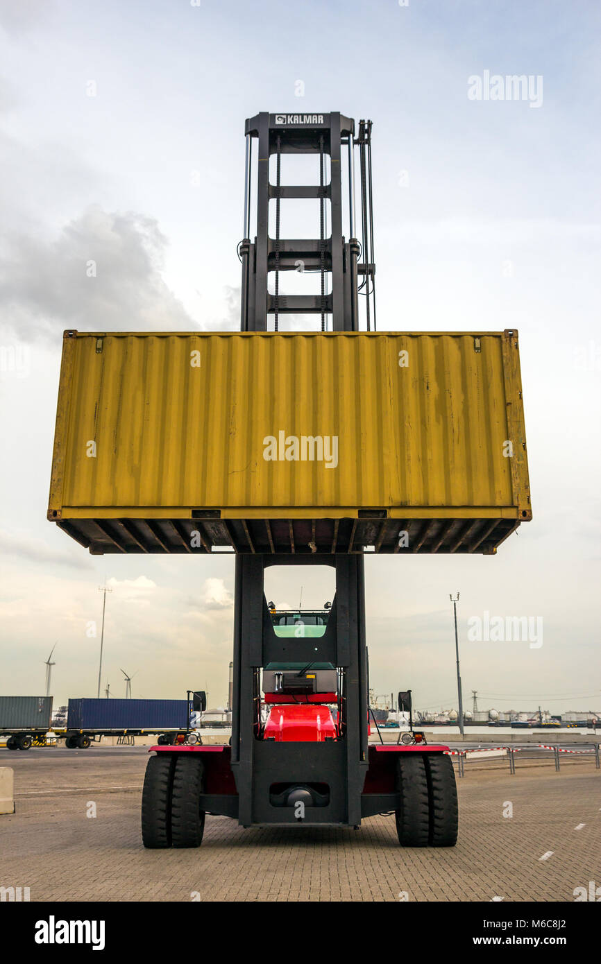 Mobile cargo container handler in action at a shipping container