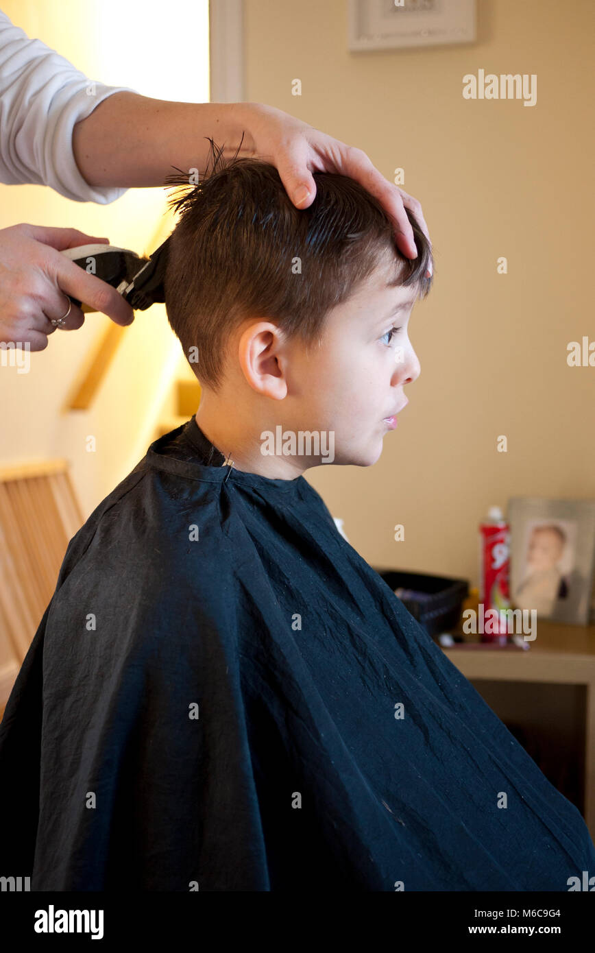 Six year old boy having his hair cut at home, UK Stock Photo - Alamy