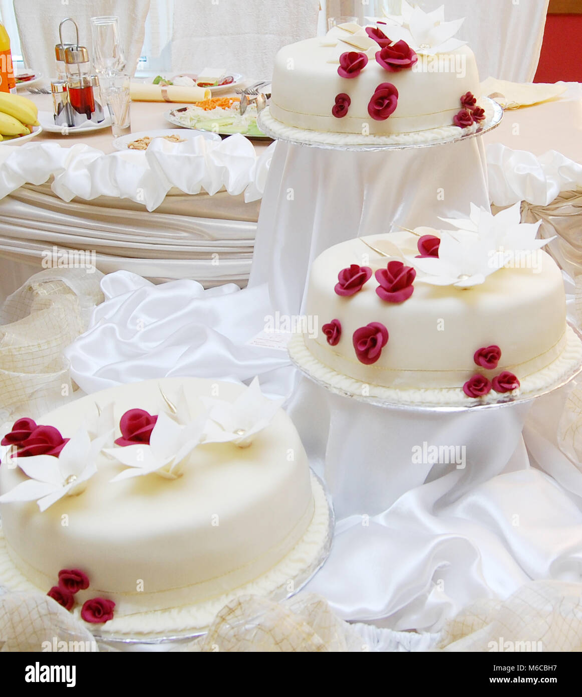 Picture of a White wedding cake with red roses Stock Photo