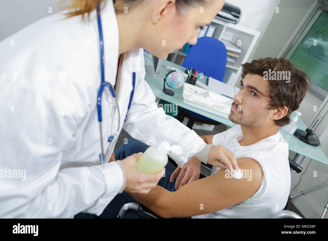 young doctor prepares an injection for a young patient Stock Photo - Alamy