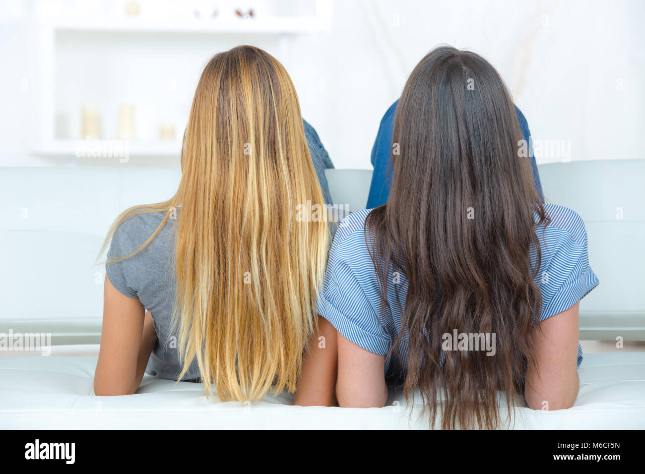 Pretty Rears In A Row Rear view of two girls with long hair Stock Photo - Alamy