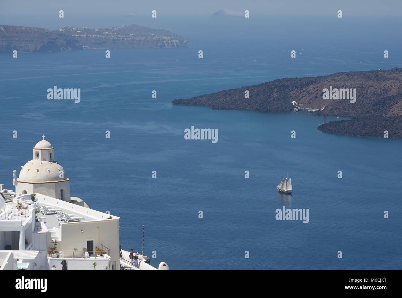 View of the caldera at Santorini/Thira, from Fira. 1917 schooner Texel No6 in the background Stock Photo
