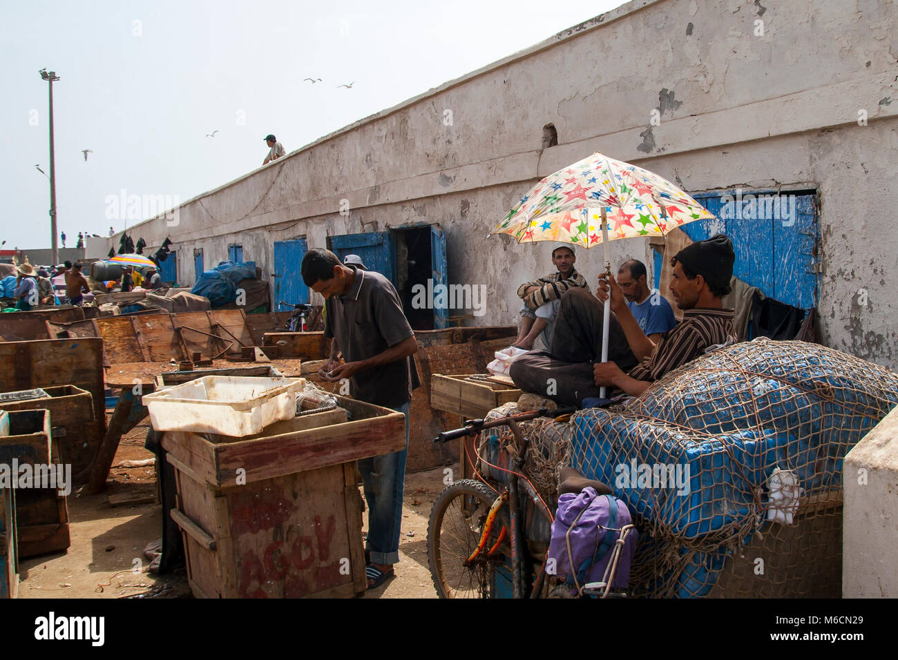 Moroccan fishermen working at the local harbor of Essaouira, Mogador in August 09, 2011, Morocco Stock Photo