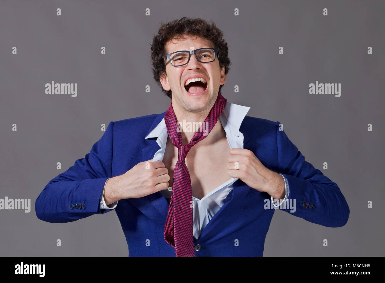 Young Guy With Curly Hair Glasses And Blue Jacket Tearing