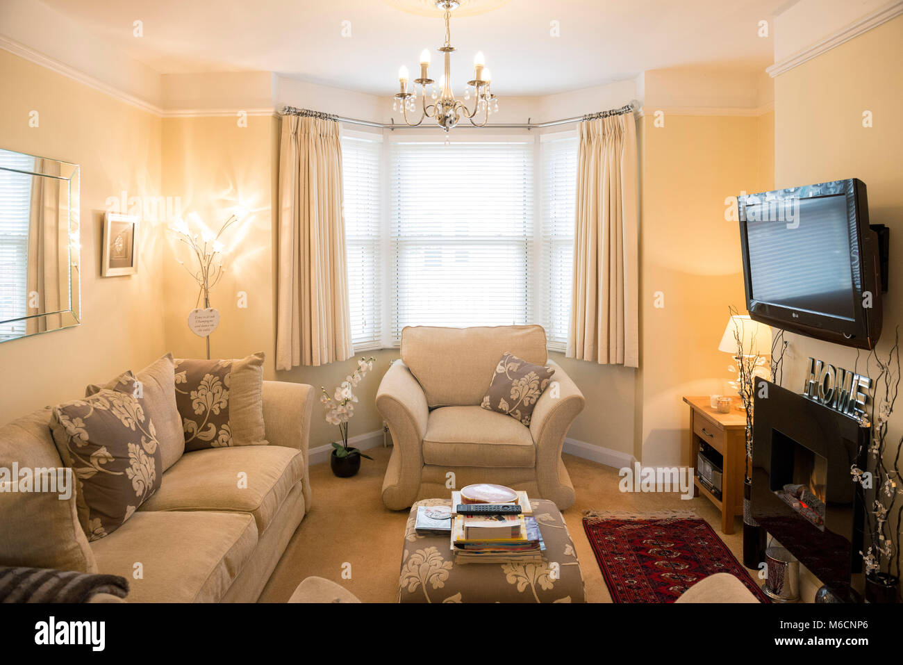 A Neutral Beige Comfortable Living Room With A Bay Window