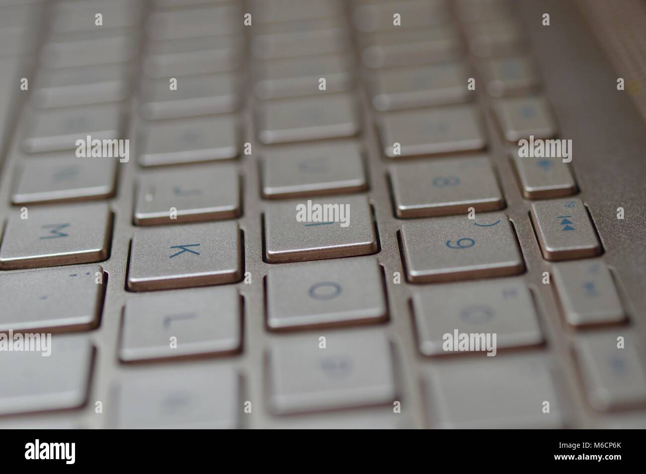 Keyboard of a bronze colored laptop Stock Photo Alamy