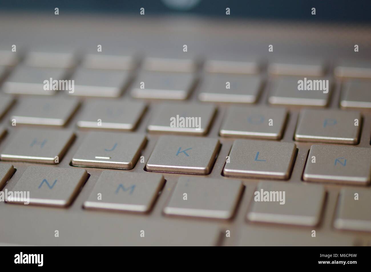 Keyboard of a bronze colored laptop Stock Photo Alamy