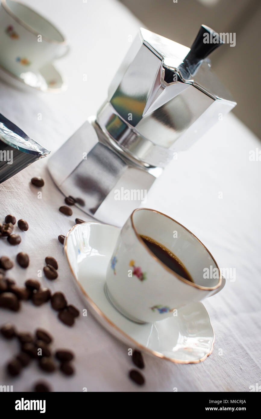 Classic italian espresso can with coffee cup and coffee beans on a