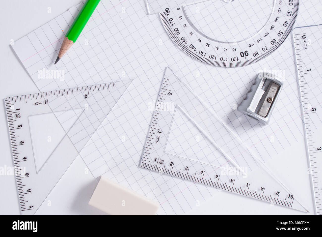 Protractor, rulers, pencil and eraser on squared paper Stock Photo Alamy
