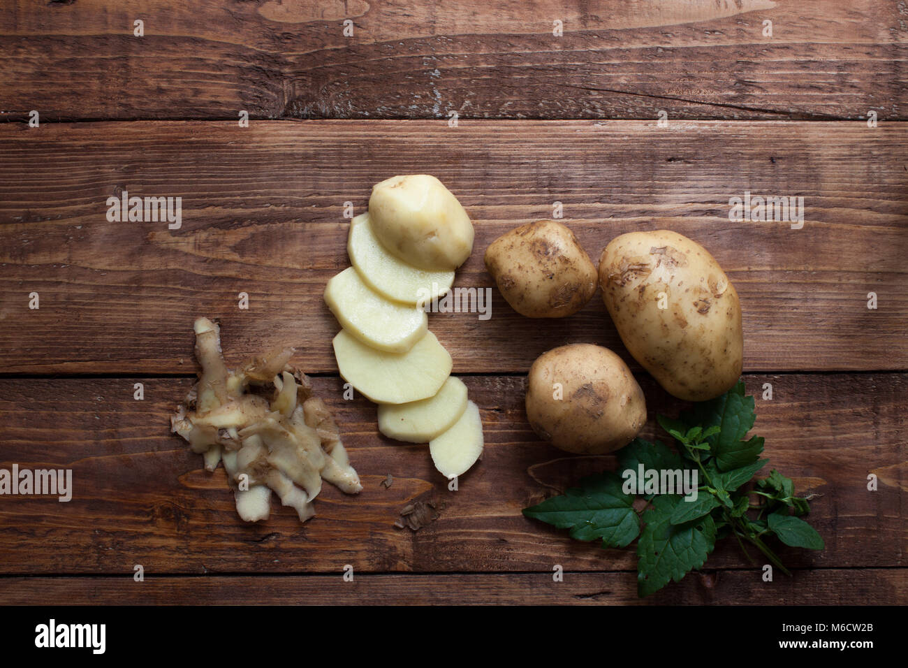 Potatoes on wooden background,sliced potatoes. Stock Photo