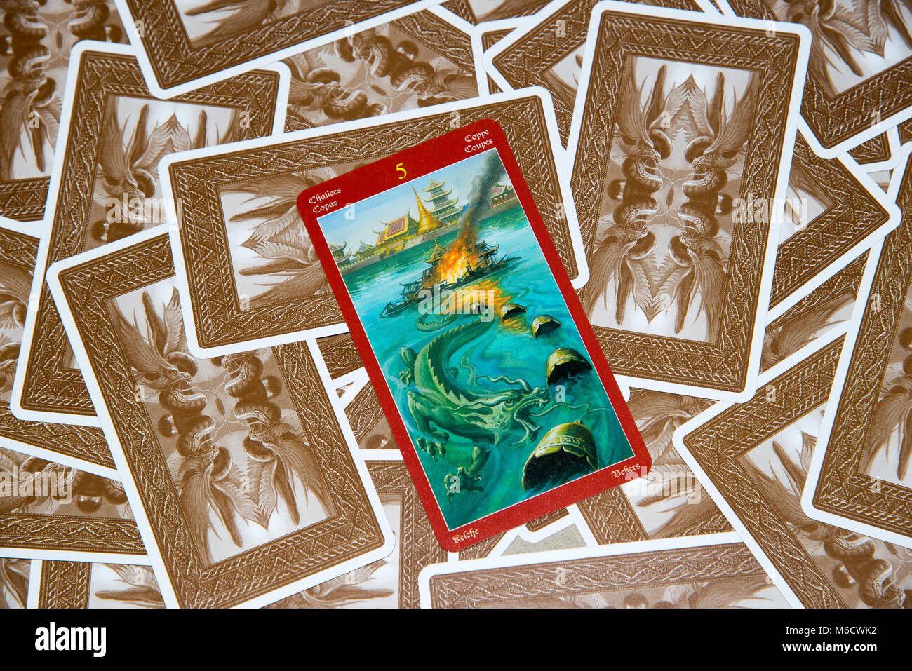 Moscow, Russia - February 18, 2018: Tarot card Five of Cups. Dragon tarot deck. Esoteric mysterious background in gothic style Stock Photo