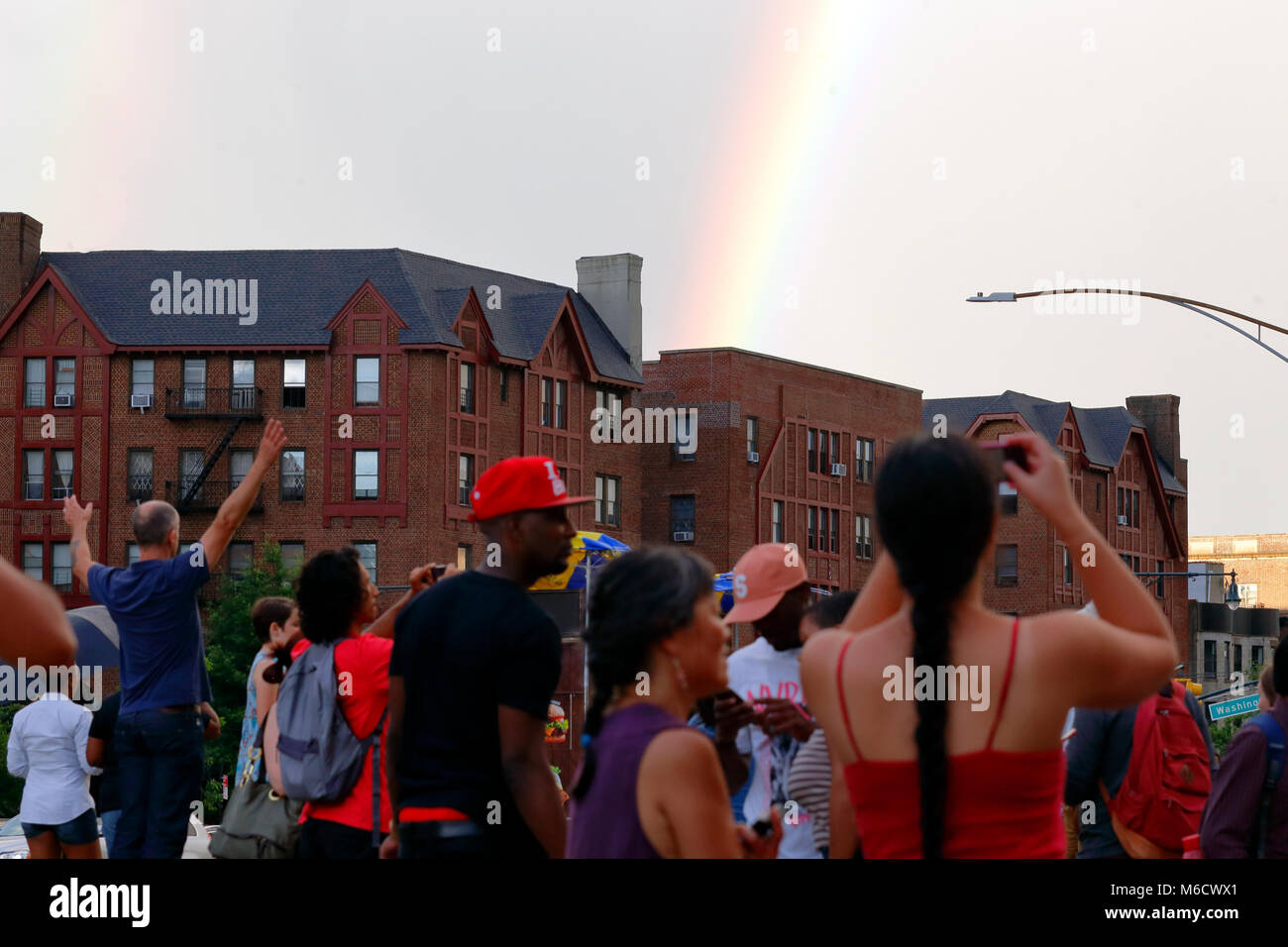 People marvel at the appearance of a double rainbow over the Brooklyn Stock Photo