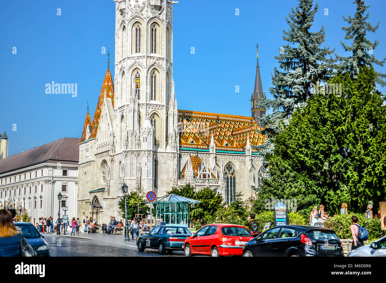 A sunny day at the Buda Castle Hill District in Budapest Hungary as tourists enjoy the view of Matthias Church Stock Photo