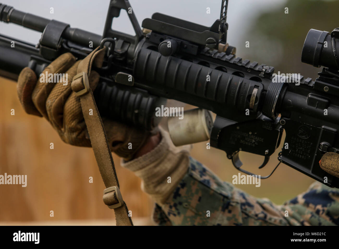 A 40mm practice round casing ejects out of an M203 grenade launcher during a grenade launcher range hosted by Marines with 2nd Air Naval Gunfire Liaison Company, II Marine Expeditionary Force Information Group at Camp Lejeune, N.C., Feb. 28, 2018. Marines with the unit routinely conduct live-fire training to sustain their proficiency in operating multiple weapon systems to provide direct support for joint, allied and coalition forces. (U.S. Marine Corps photo by Lance Cpl. Leynard Kyle Plazo) Stock Photo