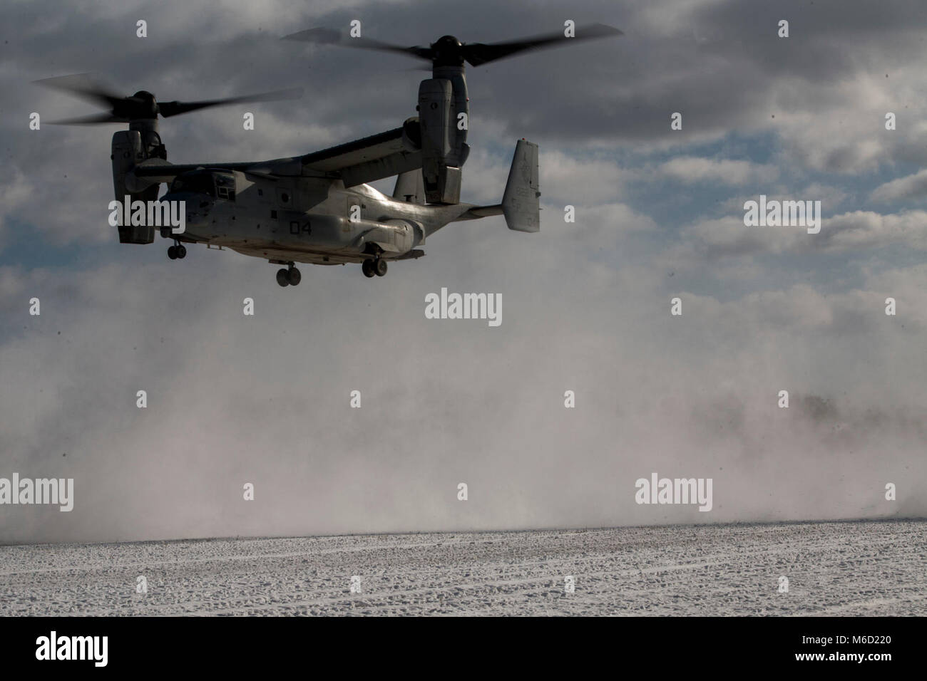 An MV-22B Osprey tiltrotor aircraft lands at Camp Sendai during fast rope drills as part of company unit-level training at Camp Sendai, Miyagi, Japan, Feb. 16, 2018. Charlie Company, Battalion Landing Team, 1st Battalion, 1st Marines, conducted the training to refine their cold-weather capabilities as part of the Ground Combat Element for the 31st MEU. As the Marine Corps' only continuously forward-deployed MEU, the 31st MEU provides a flexible force ready to perform a wide range of military operations. (U.S. Marine Corps photo by Cpl. Stormy Mendez/Released) Stock Photo