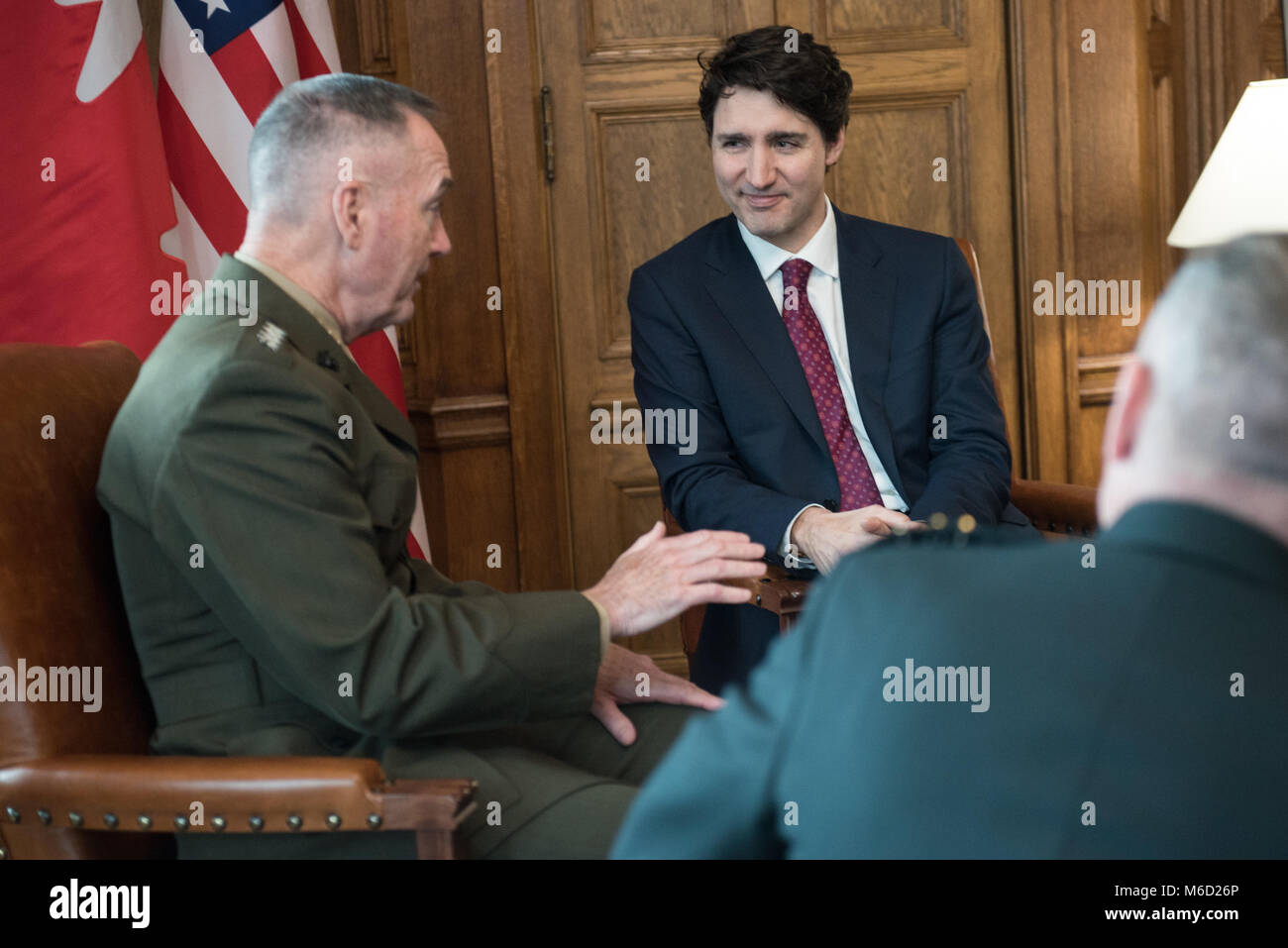 U.S. Marine Corps Gen. Joe Dunford, chairman of the Joint Chiefs of Staff, speaks with Justin Trudeau, Prime Minister of Canada, in the Canadian Parliament buildings, Ottawa, Canada, Feb. 28, 2018. Gen. Dunford was in Ottawa for meetings with senior Canadian officials on the ongoing evolution of the North American Aerospace Defense Command. (DoD Photo by U.S. Army Sgt. James K. McCann) Stock Photo