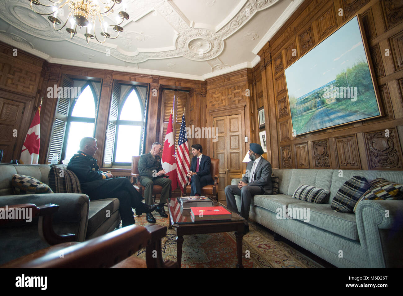 Justin Trudeau, center right, Prime Minister of Canada, meets with U.S. Marine Corps Gen. Joe Dunford, center left, chairman of the Joint Chiefs of Staff, Canadian Gen. Jonathan Vance, left, Canadian Armed Forces Chief of Defence Staff, and Harjit Singh Sajjan, right, Canadian Minister of National Defence, in his office in the Canadian Parliament buildings, Ottawa, Canada, Feb. 28, 2018. Gen. Dunford was in Ottawa for meetings with senior Canadian officials on the ongoing evolution of the North American Aerospace Defense Command. (DoD Photo by U.S. Army Sgt. James K. McCann) Stock Photo