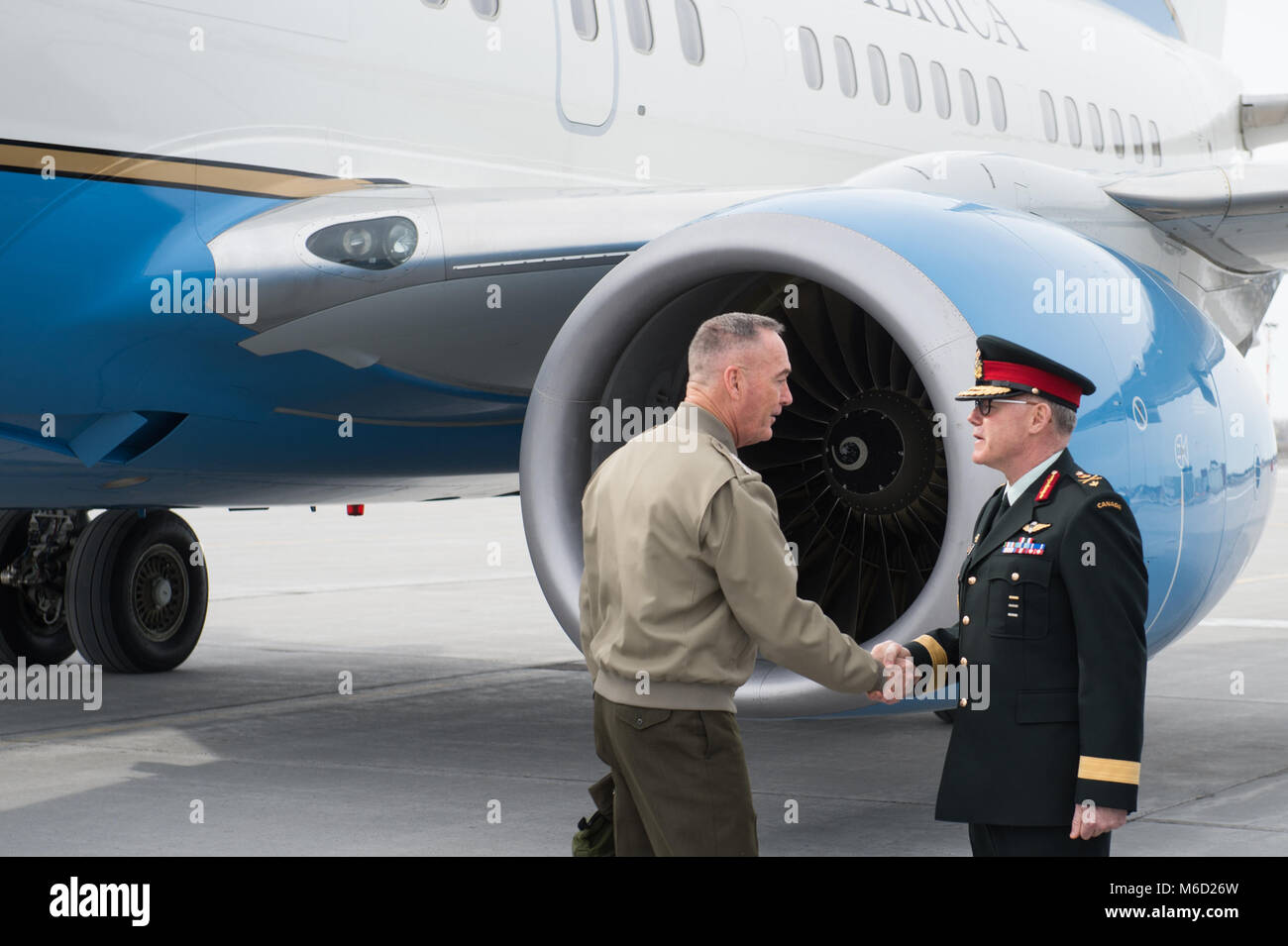 Canadian Brig. Gen. Brian McPherson, right, Chief of the Defence Staff Liaison Officer to the Chairman of the Joint Chiefs of Staff (CJCS), greets U.S. Marine Corps Gen. Joe Dunford, CJCS, upon arrival in Ottawa, Canada, Feb. 27, 2018. Gen. Dunford was in Ottawa for meetings with senior Canadian officials on the ongoing evolution of the North American Aerospace Defense Command. (DoD Photo by U.S. Army Sgt. James K. McCann) Stock Photo