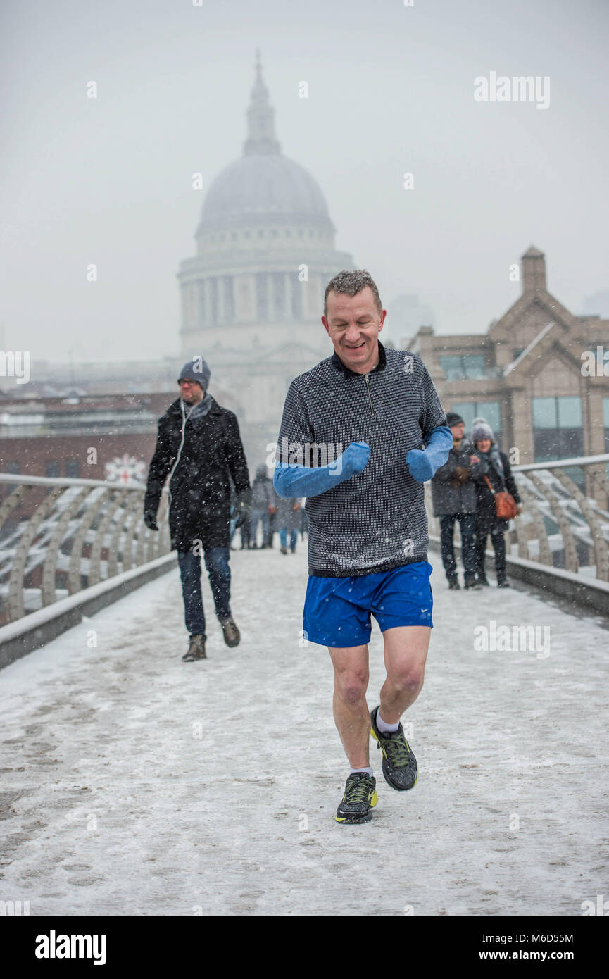 London, UK. 2nd Mar, 2018. A man seen running on the millenium bridge under heavy snow. Credit: B Rouco-3072.jpg/SOPA Images/ZUMA Wire/Alamy Live News Stock Photo