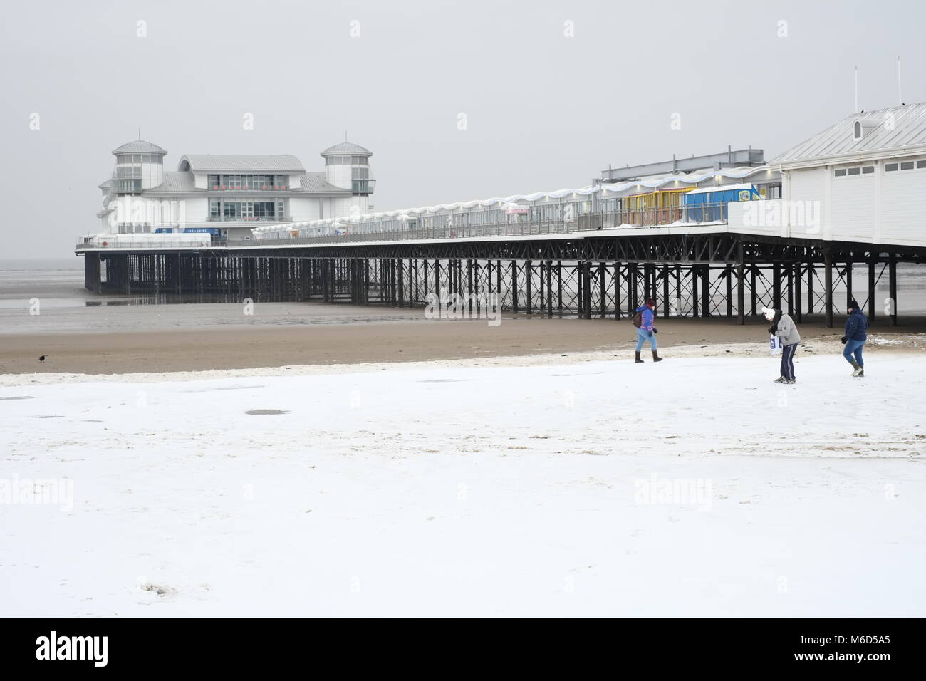The Grand Pier. Weston super mare. UK. 2nd March, 2018. Snow on the beach with people milling around.credit: /Alamy Live News Stock Photo