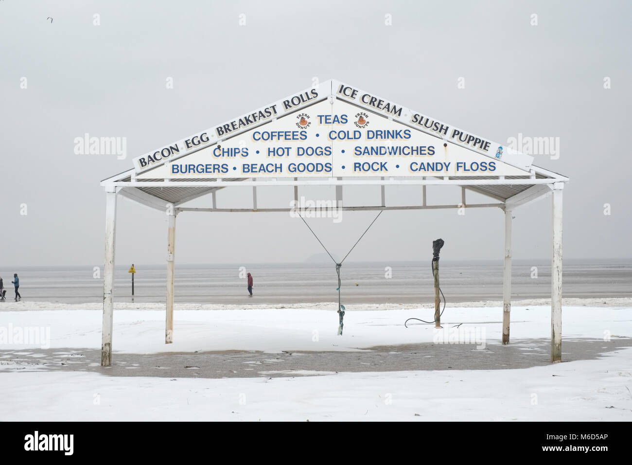 The beach, Weston super mare. UK. 2nd March, 2018. Snow on the beach near a beach side vendors shelter. Credit: Alamy Live News Stock Photo