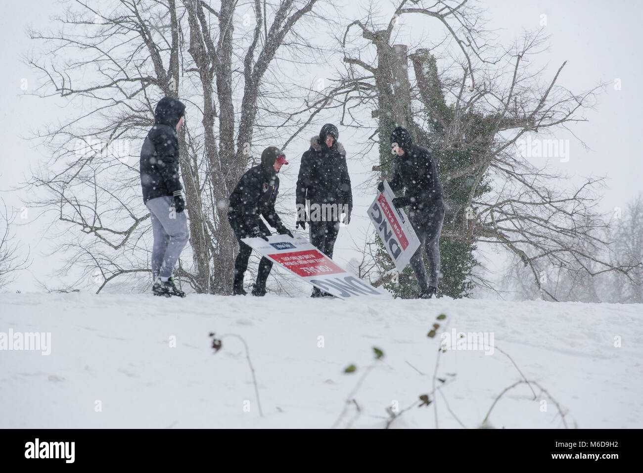 Celbridge, Kildare, Ireland. 02 Mar 2018: Teenagers taking advantage of the snowy weather having fun  sliding down the hill. Beast from the east followed by Storm Emma brought snow and high winds paralyzing the country and forcing Met Éireann to issue red warning alert across Ireland. Stock Photo